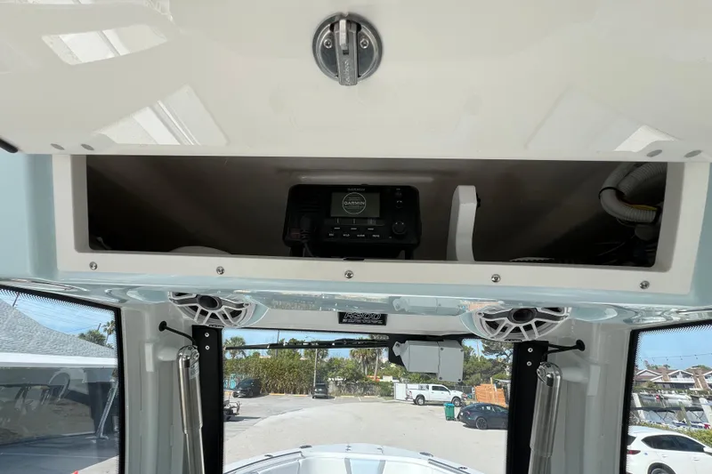 Slide: The Image of 2026 Robalo R300 Center Console boat interior with overhead storage and electronics. - 29