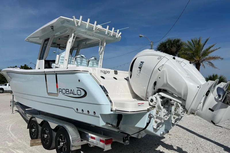 Slide: The Image of 2026 Robalo R300 Center Console boat with Yamaha engines on a trailer. - 3