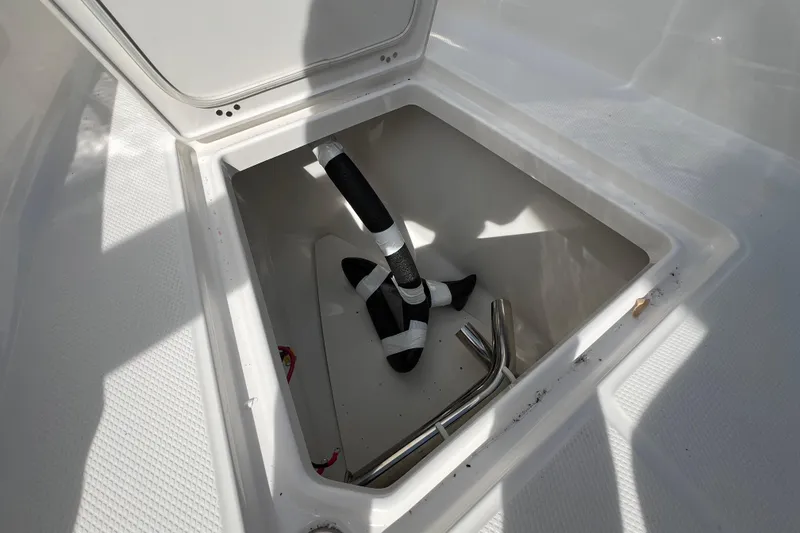 Slide: The Image of Storage compartment of 2026 Robalo R300 Center Console boat, featuring anchor and accessories. - 36