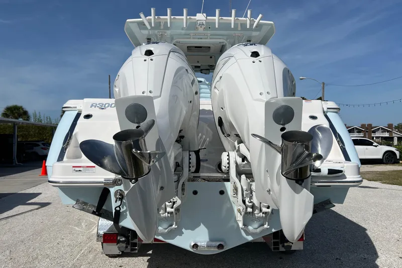 Slide: The Image of 2026 Robalo R300 Center Console boat with dual outboard engines, rear view. - 4