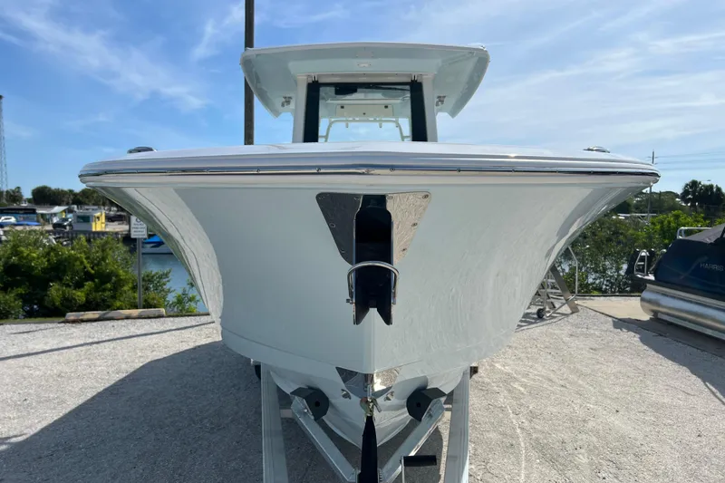 Slide: The Image of 2026 Robalo R300 Center Console boat, front view, docked on a sunny day. - 8