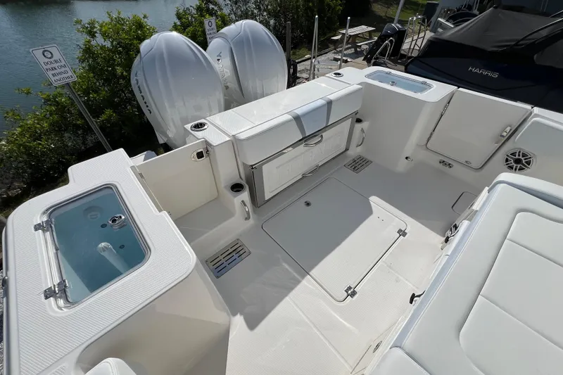 Slide: The Image of 2026 Robalo R300 Center Console boat deck with seating and storage compartments. - 9