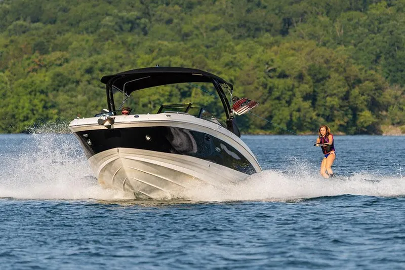 Slide: The Image of Manufacturer Provided Image: 2025 Sea Ray SDX 290 towing a wakeboarder on a scenic lake. - 4