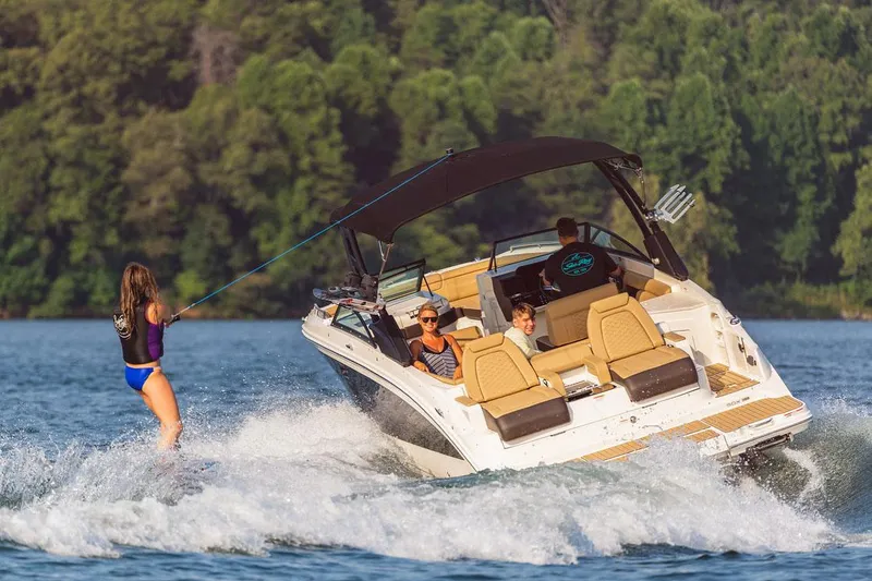 Slide: The Image of Manufacturer Provided Image: 2025 Sea Ray SDX 290 towing a wakeboarder on a sunny lake. - 5