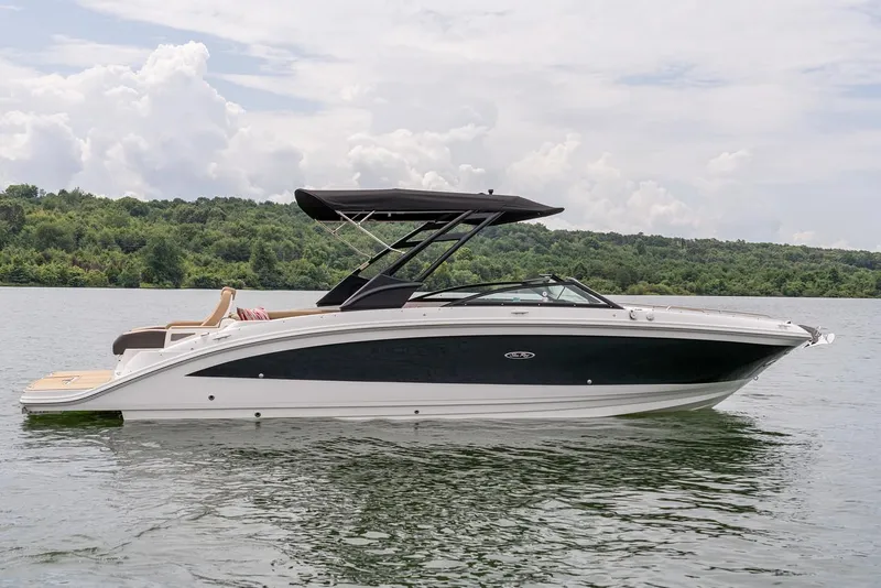 Slide: The Image of Manufacturer Provided Image: 2025 Sea Ray SDX 290 boat on a calm lake with lush greenery. - 6