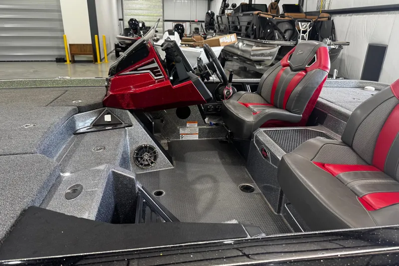Slide: The Image of 2022 Ranger Z520R boat interior with red and gray seats, steering console, and spacious deck. - 11
