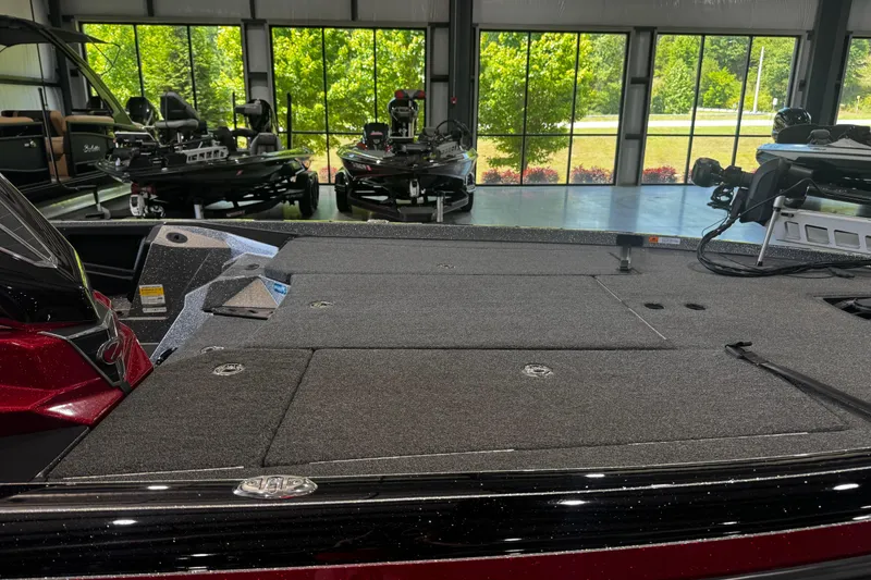 Slide: The Image of 2022 Ranger Z520R boat interior in showroom with large windows and greenery outside. - 4