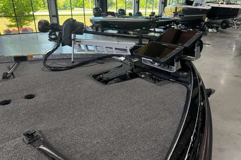 Slide: The Image of 2022 Ranger Z520R boat interior with advanced navigation equipment and spacious deck in showroom. - 5