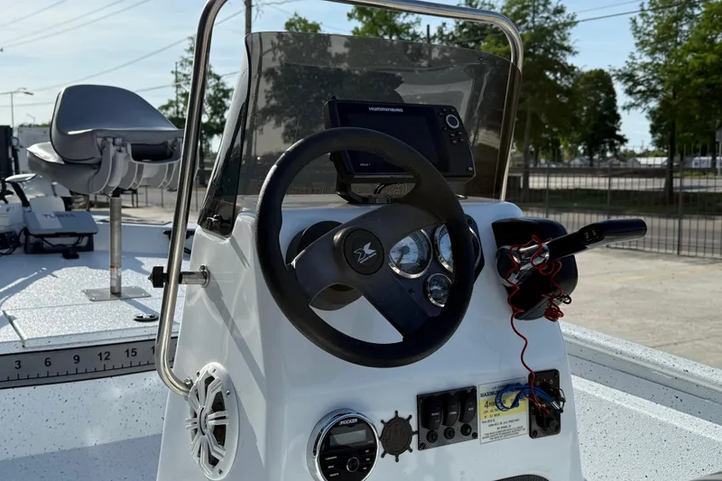 Slide: The Image of 2021 Alumaweld Xpress boat dashboard with steering wheel and navigation equipment. - 10