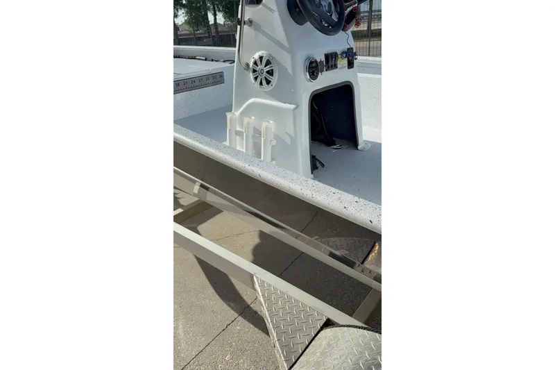 Slide: The Image of 2021 Alumaweld Xpress boat interior with steering console and storage compartment. - 15