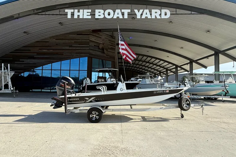 Slide: The Image of 2021 Alumaweld Xpress boat on trailer at The Boat Yard dealership. - 2