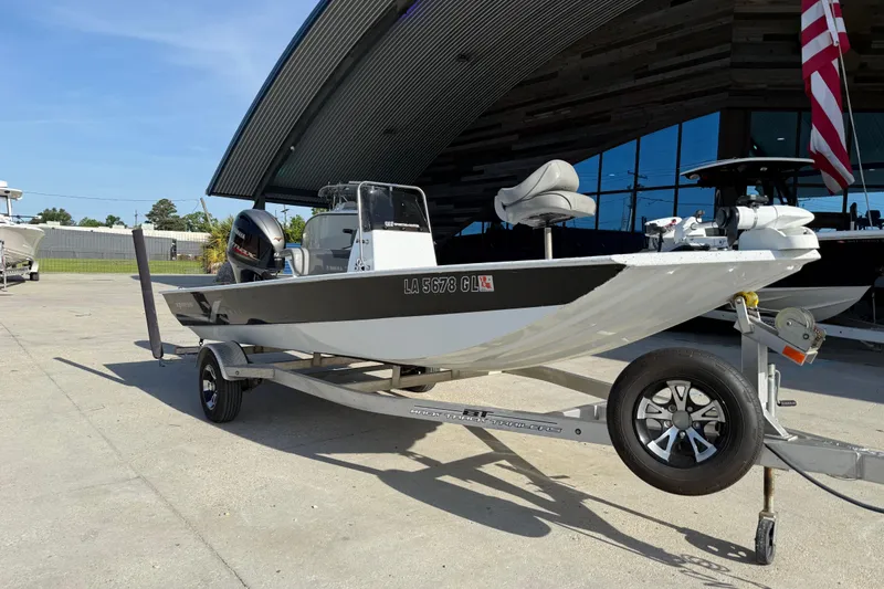 Slide: The Image of 2021 Alumaweld Xpress boat on trailer, parked outdoors near modern building. - 4
