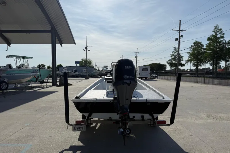 Slide: The Image of 2021 Alumaweld Xpress boat with outboard motor in a parking lot. - 8