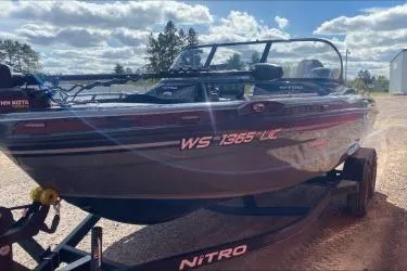 Slide: The Image of 2021 Nitro ZV19 boat on trailer under a partly cloudy sky. - 10