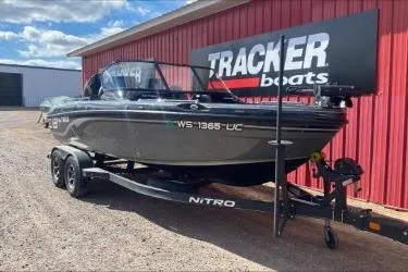 Slide: The Image of 2021 Nitro ZV19 boat on trailer near red building under blue sky. - 5