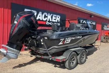 Slide: The Image of 2021 Nitro ZV19 boat on trailer, parked near Tracker Boats building. - 6