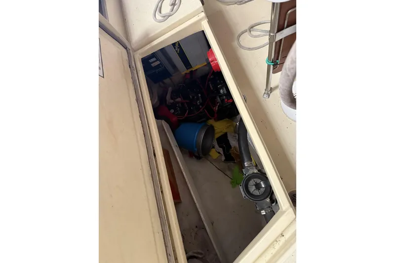 Slide: The Image of Interior view of a 1977 Islander 32 sailboat compartment with equipment and wiring. - 12