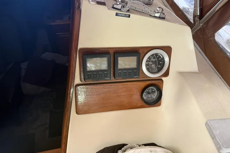 Slide: The Image of 1977 Islander 32 sailboat dashboard with speed, depth, and navigation instruments. - 15