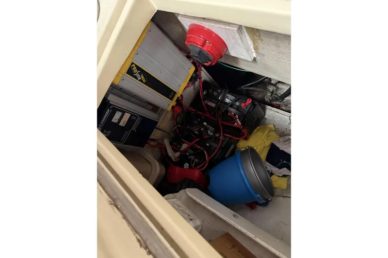 Slide: The Image of Electrical components and storage area inside a 1977 Islander 32 boat. - 16