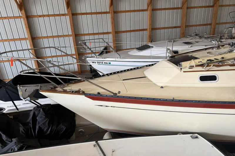 Slide: The Image of 1977 Islander 32 sailboat stored indoors, showcasing sleek design and classic features. - 2