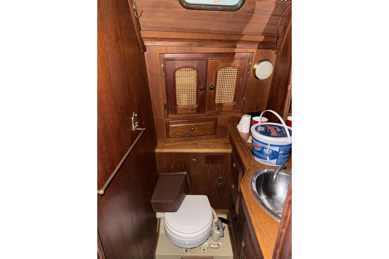 Slide: The Image of 1977 Islander 32 sailboat bathroom with wooden cabinetry and compact sink. - 20