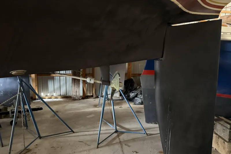 Slide: The Image of 1977 Islander 32 sailboat hull and rudder in a storage facility. - 22
