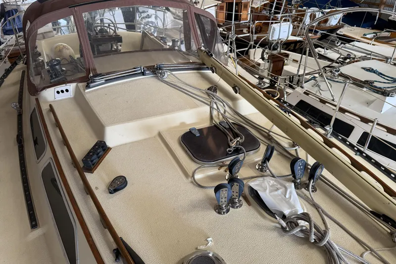 Slide: The Image of 1977 Islander 32 sailboat deck with rigging and cockpit view in marina. - 6