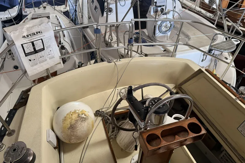 Slide: The Image of Cockpit of a 1977 Islander 32 sailboat with steering wheel and navigation equipment. - 9