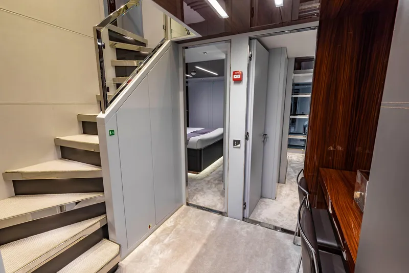 Slide: The Image of Luxurious interior of 2020 Riva 110' Dolcevita yacht featuring elegant staircase and modern bedroom. - 12