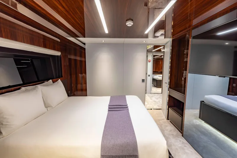 Slide: The Image of Luxurious bedroom interior on 2020 Riva 110' Dolcevita yacht, featuring elegant wood paneling. - 20