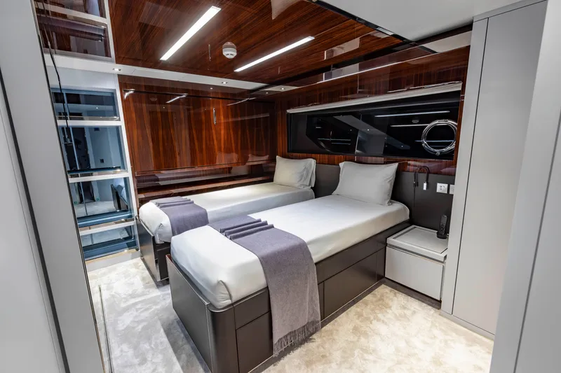 Slide: The Image of Luxurious twin bedroom on 2020 Riva 110' Dolcevita yacht with modern wood paneling. - 22