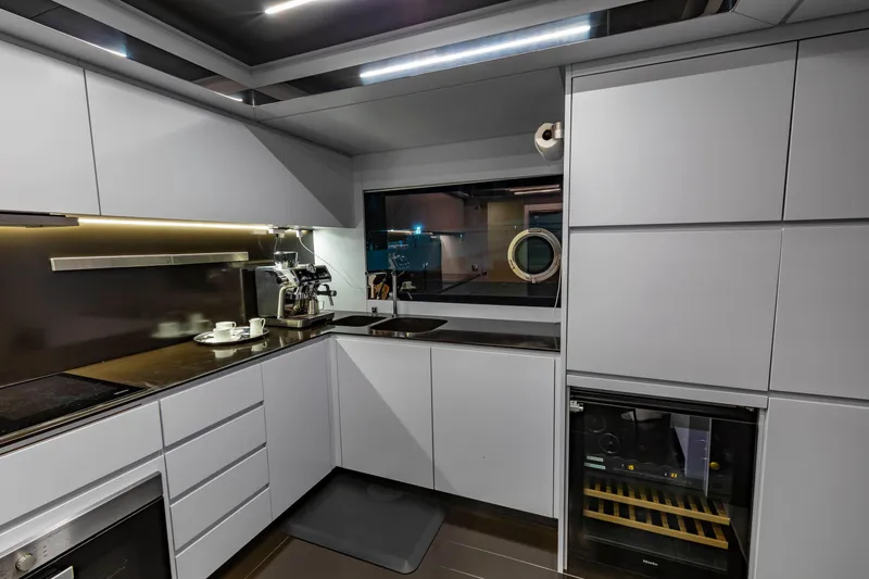 Slide: The Image of Modern kitchen interior on 2020 Riva 110' Dolcevita yacht, featuring sleek cabinetry and appliances. - 24