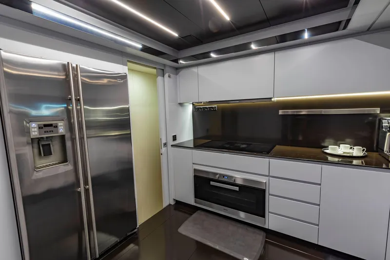 Slide: The Image of Modern kitchen interior on 2020 Riva 110' Dolcevita yacht, featuring sleek appliances and minimalist design. - 25