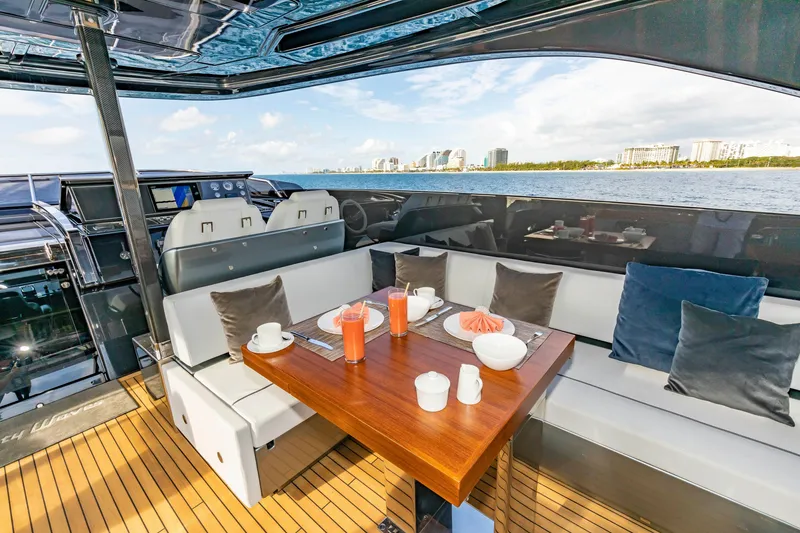 Slide: The Image of Luxurious 2020 Riva 110' Dolcevita yacht interior with elegant dining setup and ocean view. - 33