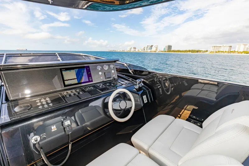 Slide: The Image of Luxurious 2020 Riva 110' Dolcevita yacht cockpit with modern controls, overlooking ocean and cityscape. - 35