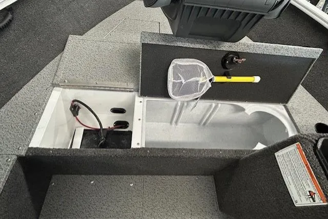 Slide: The Image of 2026 Lund 1650 Rebel XL SS boat interior with storage compartments and fishing net. - 10