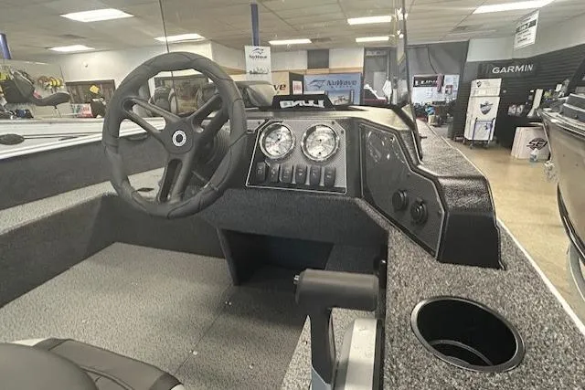 Slide: The Image of 2026 Lund 1650 Rebel XL SS boat interior with steering wheel and dashboard controls. - 11