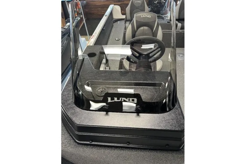 Slide: The Image of 2026 Lund 1650 Rebel XL SS boat interior with steering wheel and seating. - 13