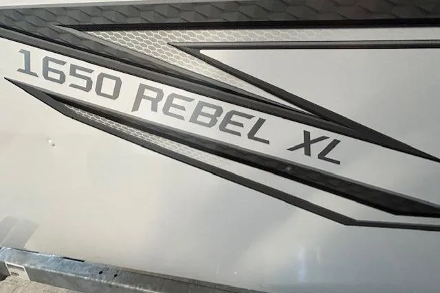 Slide: The Image of 2026 Lund 1650 Rebel XL SS boat decal with sleek design elements. - 2