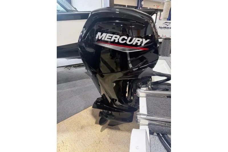 Slide: The Image of 2026 Lund 1650 Rebel XL SS with Mercury outboard motor, displayed indoors. - 5