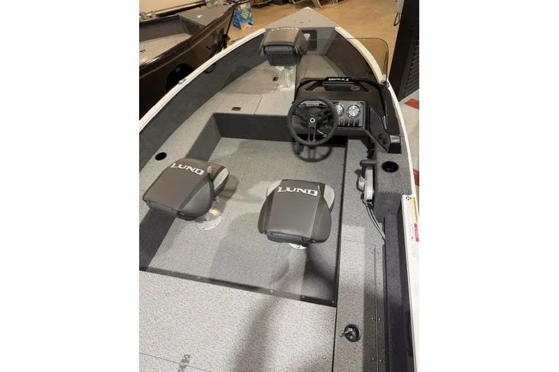 Slide: The Image of 2026 Lund 1650 Rebel XL SS boat interior with steering console and seating. - 6
