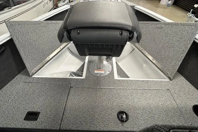 Slide: The Image of 2026 Lund 1650 Rebel XL SS boat interior with storage compartments and seating. - 9