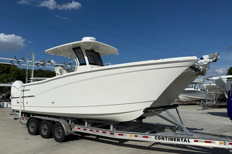The Image of 2024 World Cat 280 CC-X boat on trailer under clear blue sky. - 0
