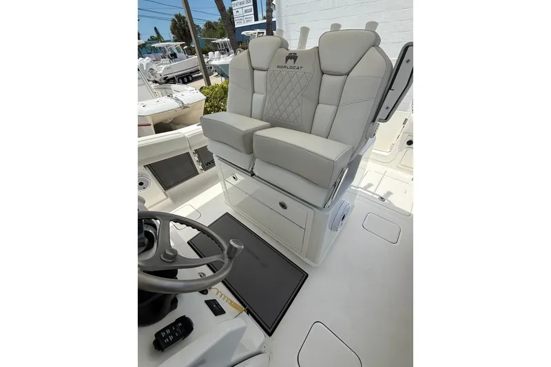 Slide: The Image of 2024 World Cat 280 CC-X boat interior with luxurious seating and steering wheel. - 11