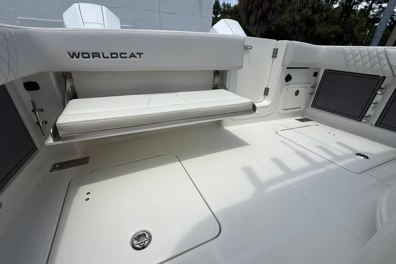 Slide: The Image of 2024 World Cat 280 CC-X boat interior with white seating and storage compartments. - 13