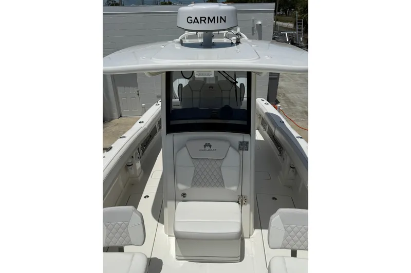 Slide: The Image of 2024 World Cat 280 CC-X boat interior with Garmin equipment, featuring white seating and modern design. - 7