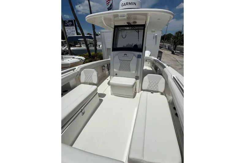 Slide: The Image of 2024 World Cat 280 CC-X boat interior with white seating and Garmin equipment. - 8