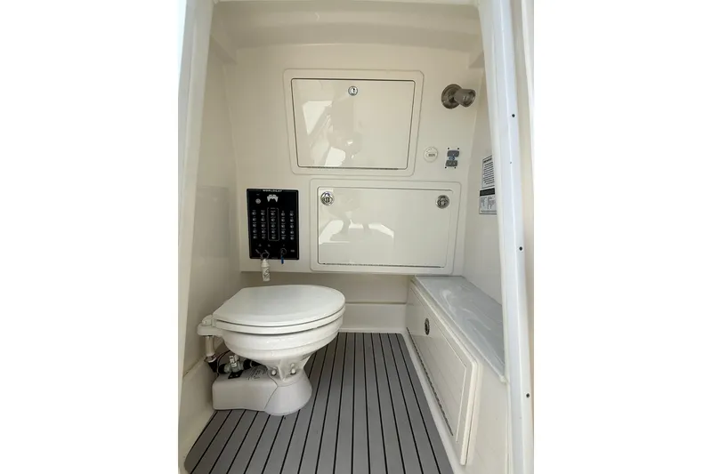 Slide: The Image of 2024 World Cat 280 CC-X boat interior with toilet and storage compartments. - 9