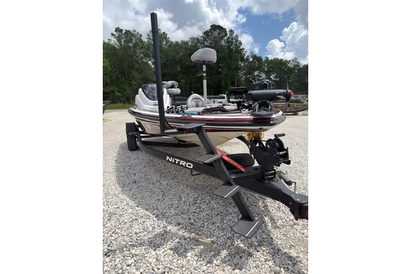Slide: The Image of 2021 Nitro Z17 boat on trailer, parked on gravel, under a partly cloudy sky. - 4