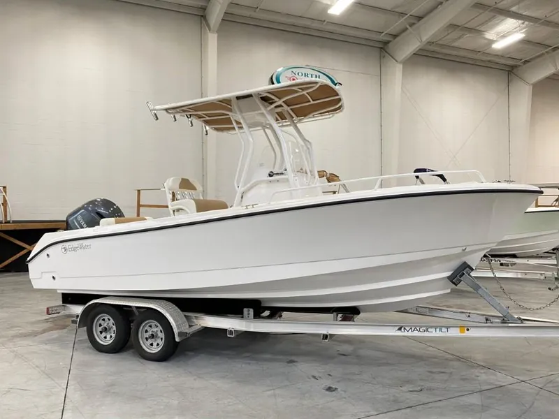 The Image of 2025 Edgewater 208CC boat on trailer in indoor showroom. - 0
